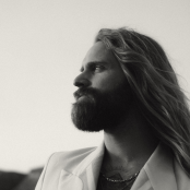Musician Sam Ruder facing left in black and white.